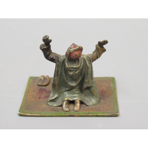 291 - Miniature Austrian cold painted bronze figure of an Arab kneeling on a prayer rug, 1.75ins wide