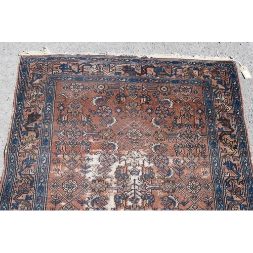 3 - Small Kurdish rug with an all-over stylised floral design on a brick red ground with borders, 4ft 8i... 