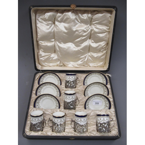 555 - Cased set of six Cauldron coffee cans and saucers with silver holders