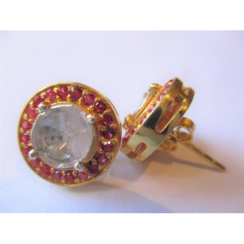 693 - Pair of circular Indian yellow metal ear studs set large flat cut diamonds and a halo of rubies