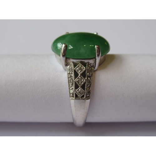 719 - 18ct White gold oval jade set ring with diamond set shoulders