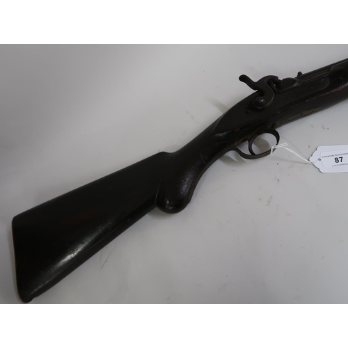 87 - Antique flintlock rifle (converted to percussion cap) having ramrod, brass mounts and mahogany stock... 
