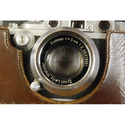 221 - Leica 35mm roll film camera, marked Leica DRP Ernst Leitz Wetzlar No. 212768, in original leather ca... 