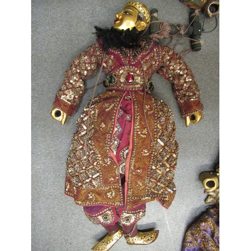 256 - Collection of seven various large Burmese carved wooden puppets with sequin decorated costumes, each... 