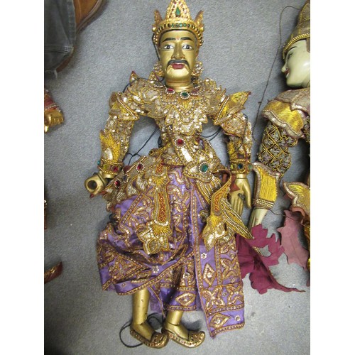 256 - Collection of seven various large Burmese carved wooden puppets with sequin decorated costumes, each... 