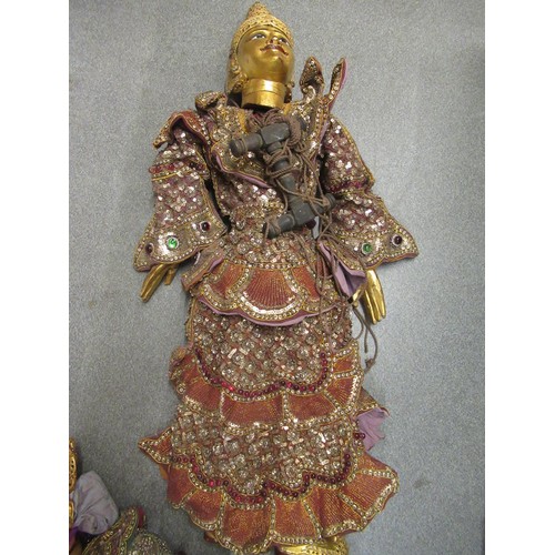 256 - Collection of seven various large Burmese carved wooden puppets with sequin decorated costumes, each... 