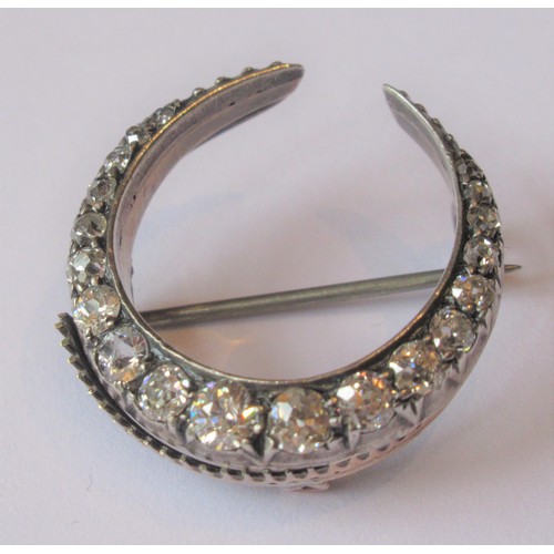 720 - Victorian crescent brooch set graduated old cut diamonds