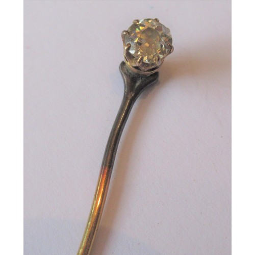 702 - Yellow metal solitaire diamond stick pin of approximately 0.2ct