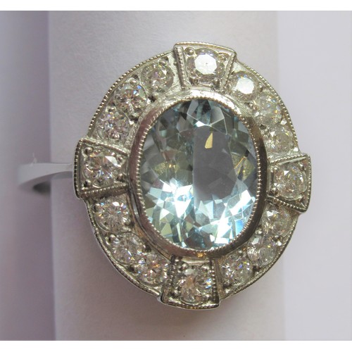 708 - Platinum oval aquamarine and diamond cluster ring