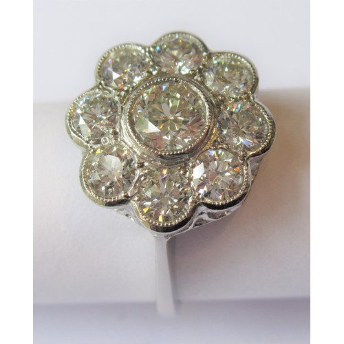 709 - Platinum diamond flowerhead cluster ring, the nine diamonds approximately 1.50ct total