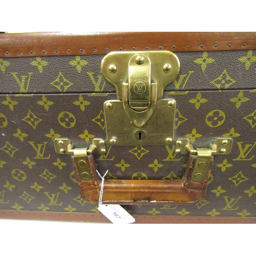 167 - Vintage Louis Vuitton suitcase with brass catches and corner mounts, the hinged lid enclosing a void... 