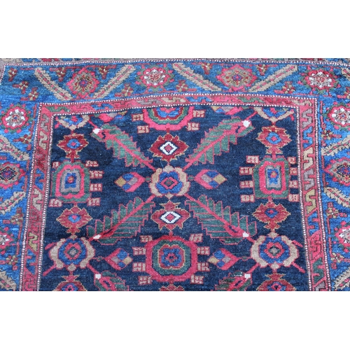 26 - Antique Kurdish rug, having all over stylised floral design, midnight ground with multiple borders, ... 