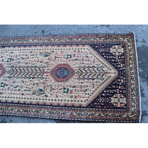 6 - Abadeh runner with a medallion and all-over design on a blue ground with borders, 3.1m x 95cms appro... 