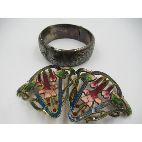 882 - Gilt metal and enamel decorated buckle of floral design, together with a silver bangle