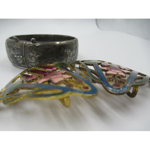 882 - Gilt metal and enamel decorated buckle of floral design, together with a silver bangle