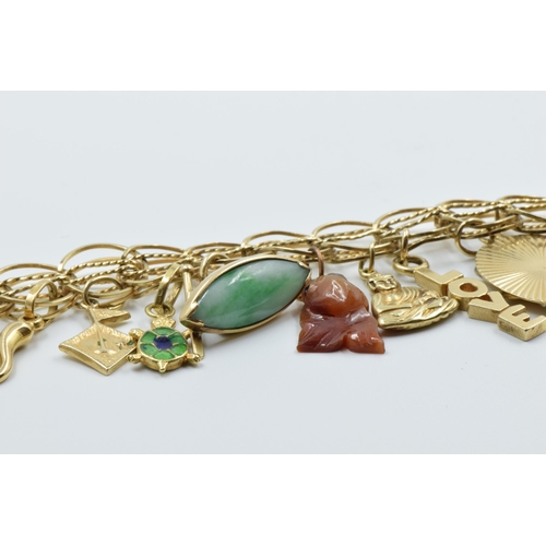 885 - 14ct Gold charm bracelet mounted with various charms including two 18ct, seven 14ct and seven unmark... 