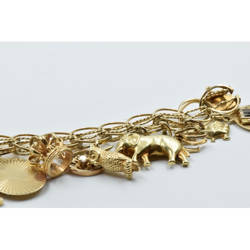 885 - 14ct Gold charm bracelet mounted with various charms including two 18ct, seven 14ct and seven unmark... 