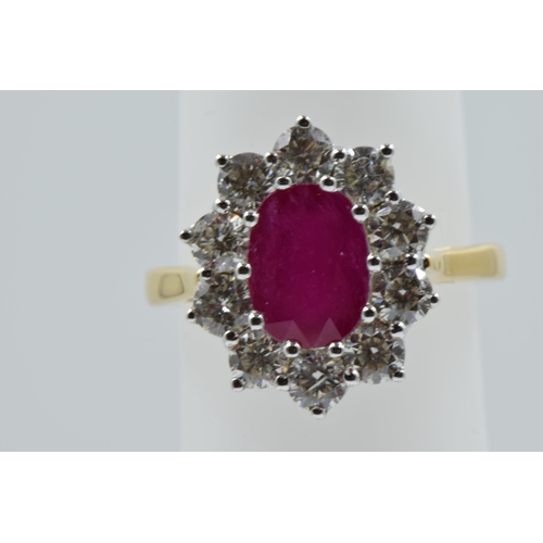 888 - 18ct Yellow gold oval ruby and diamond cluster ring, the ruby approximately 2.25ct, the diamonds app... 