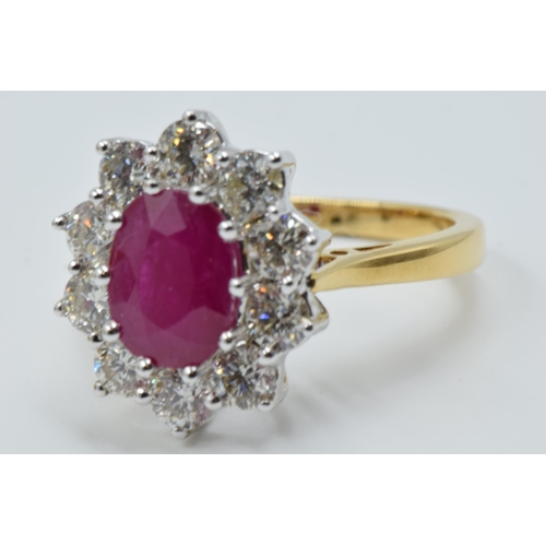 888 - 18ct Yellow gold oval ruby and diamond cluster ring, the ruby approximately 2.25ct, the diamonds app... 