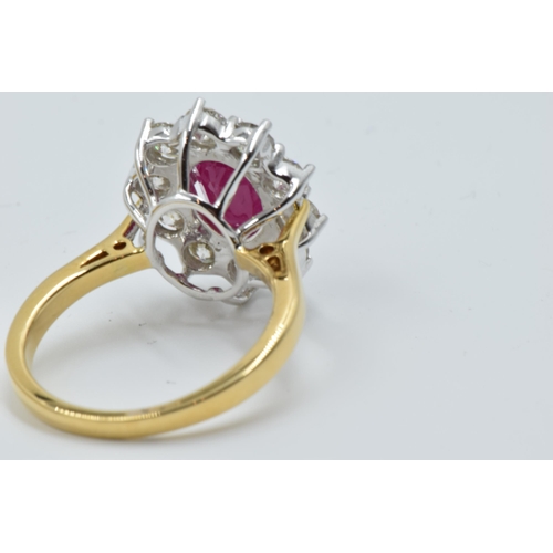 888 - 18ct Yellow gold oval ruby and diamond cluster ring, the ruby approximately 2.25ct, the diamonds app... 