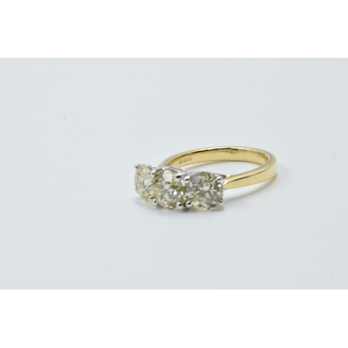 889 - 18ct White and yellow gold four claw diamond trilogy ring, the diamonds approximately 3.40ct total, ... 