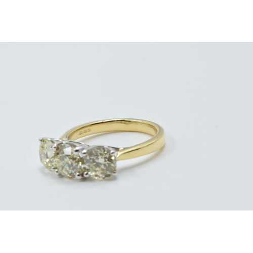 889 - 18ct White and yellow gold four claw diamond trilogy ring, the diamonds approximately 3.40ct total, ... 