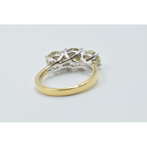 889 - 18ct White and yellow gold four claw diamond trilogy ring, the diamonds approximately 3.40ct total, ... 