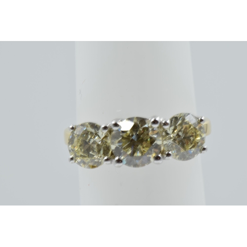 889 - 18ct White and yellow gold four claw diamond trilogy ring, the diamonds approximately 3.40ct total, ... 