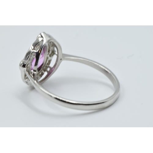 898 - Platinum ring set oval pink sapphire surrounded by brilliant cut diamonds