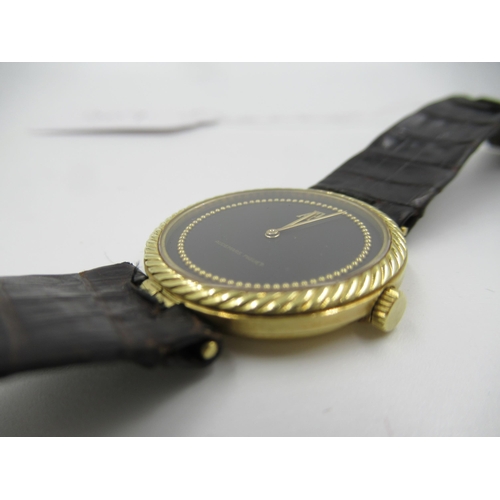 907 - Audemars Piguet, ladies 18ct gold cased manual wristwatch with black dial, on a brown leather strap ... 