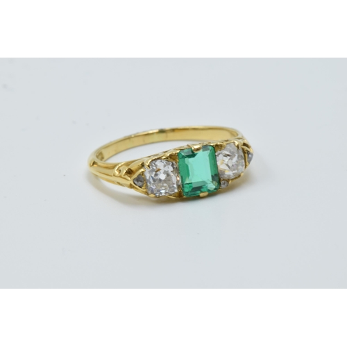 926 - 18ct Yellow gold three stone emerald and diamond ring, the emerald approximately 6mm x 4.5mm, flanke... 