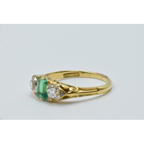 926 - 18ct Yellow gold three stone emerald and diamond ring, the emerald approximately 6mm x 4.5mm, flanke... 