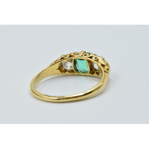 926 - 18ct Yellow gold three stone emerald and diamond ring, the emerald approximately 6mm x 4.5mm, flanke... 