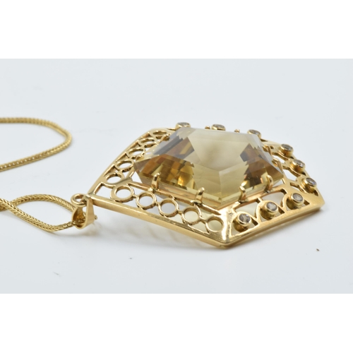 929 - An unmarked high carat citrine and diamond set pendant of irregular pierced geometric form on an 18c... 