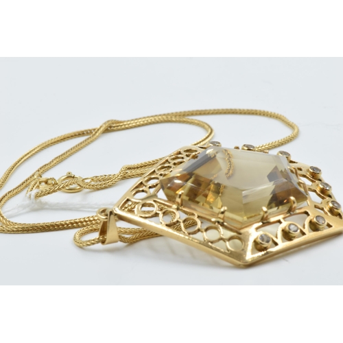 929 - An unmarked high carat citrine and diamond set pendant of irregular pierced geometric form on an 18c... 