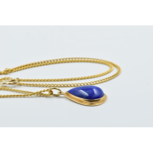 953 - Middle Eastern yellow metal and lapis teardrop pendant on a yellow metal curb link chain, the clasp ... 