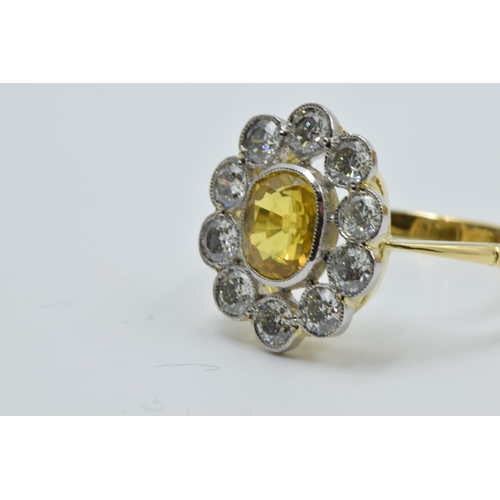 958 - 18ct Yellow gold ring set oval yellow sapphire surrounded by brilliant cut diamonds