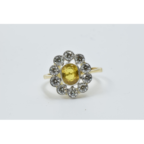 958 - 18ct Yellow gold ring set oval yellow sapphire surrounded by brilliant cut diamonds