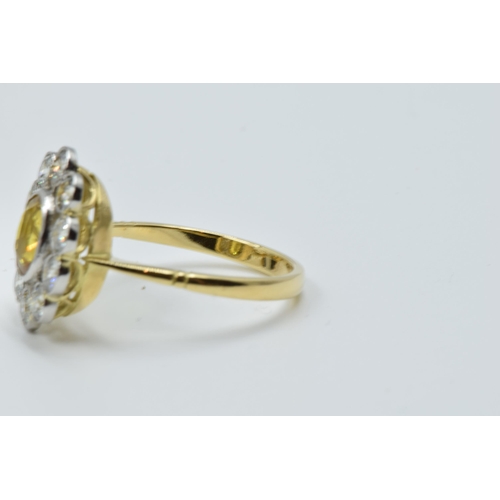 958 - 18ct Yellow gold ring set oval yellow sapphire surrounded by brilliant cut diamonds