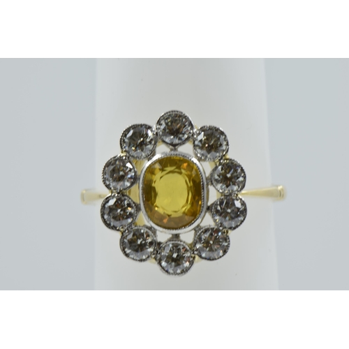 958 - 18ct Yellow gold ring set oval yellow sapphire surrounded by brilliant cut diamonds