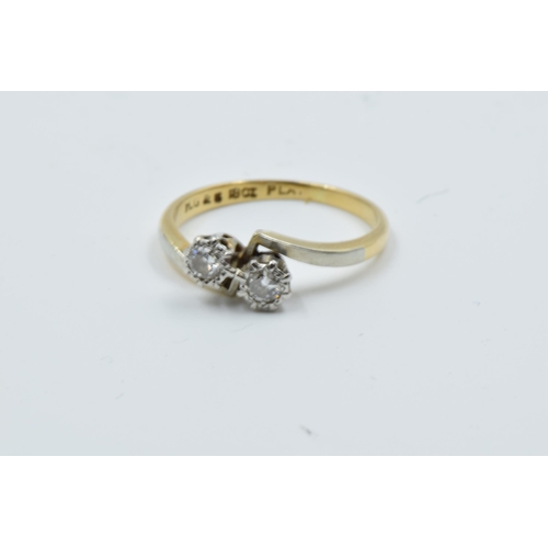 965 - Two 18ct yellow gold two stone diamond crossover rings, together with a diamond solitaire ring