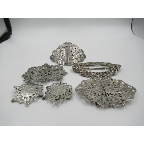 970 - Collection of four various silver nurse's belt buckles together with another similar