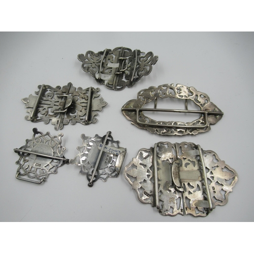 970 - Collection of four various silver nurse's belt buckles together with another similar