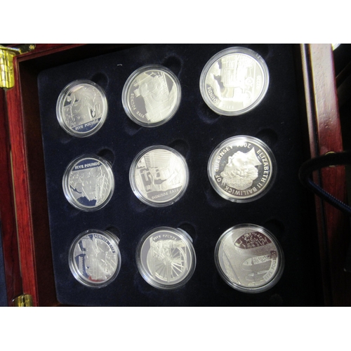 980 - Two mahogany cased sets of eighteen silver proof five pound coins, of railway related subjects, anot... 