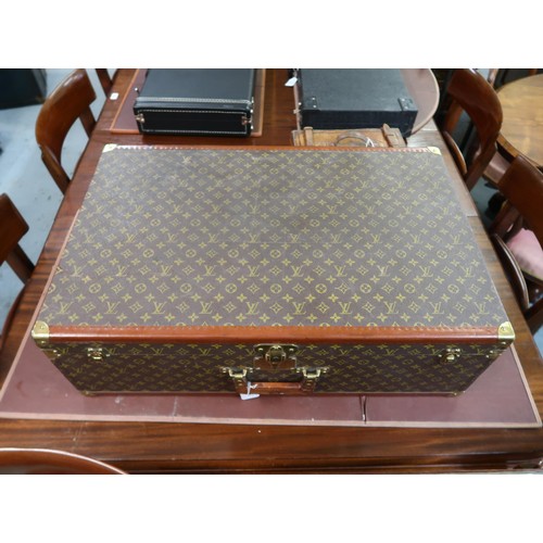 167 - Vintage Louis Vuitton suitcase with brass catches and corner mounts, the hinged lid enclosing a void... 