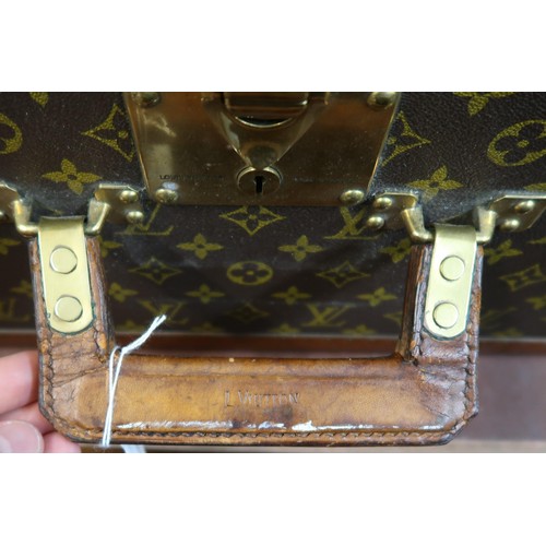 167 - Vintage Louis Vuitton suitcase with brass catches and corner mounts, the hinged lid enclosing a void... 