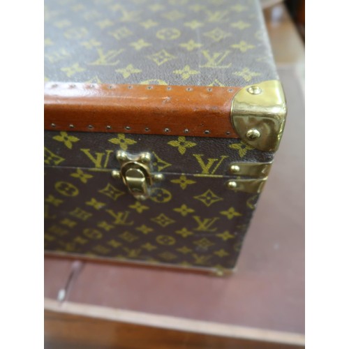 167 - Vintage Louis Vuitton suitcase with brass catches and corner mounts, the hinged lid enclosing a void... 