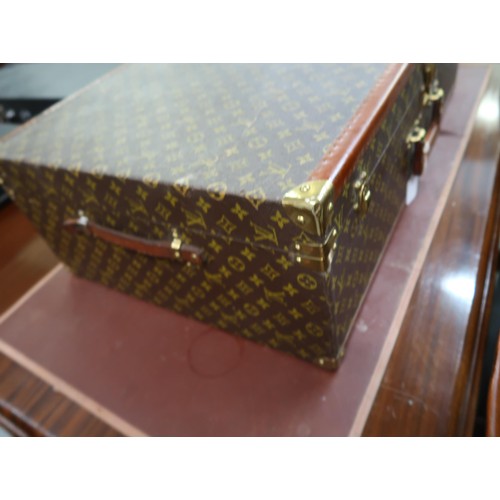 167 - Vintage Louis Vuitton suitcase with brass catches and corner mounts, the hinged lid enclosing a void... 