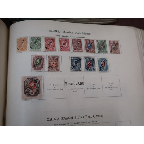 219 - Two large green Ideal postage stamp albums containing an extensive collection of World stamps, toget... 