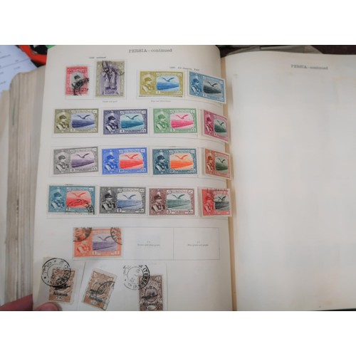 219 - Two large green Ideal postage stamp albums containing an extensive collection of World stamps, toget... 